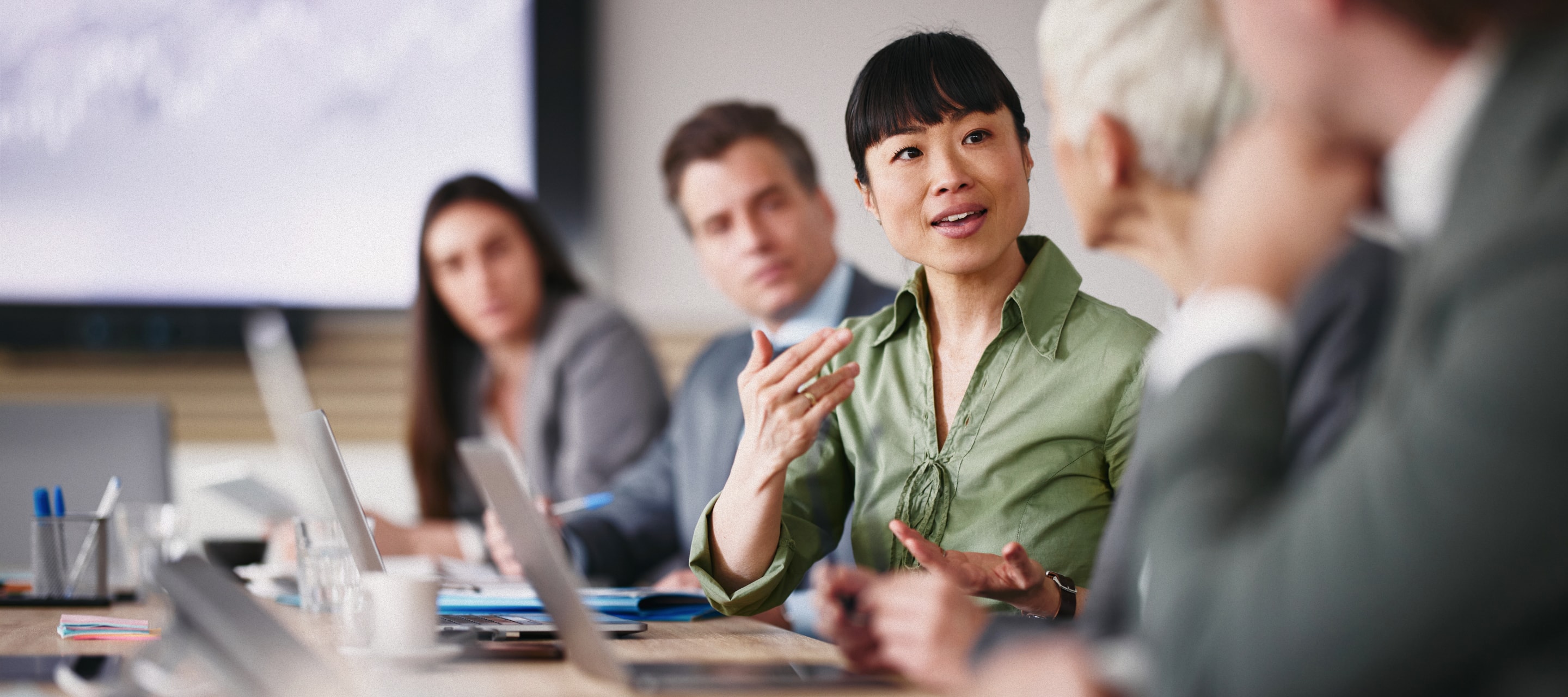Business partners working on the project in the office using laptop, sharing ideas in the business meeting.